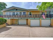 Charming multi-level home featuring an elevated balcony and convenient three-car garage at 8300 W 67Th Ave, Arvada, CO 80004