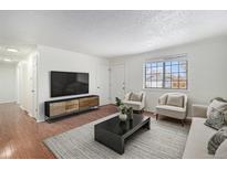 Bright living room featuring hardwood floors and comfortable seating at 4198 E 117Th Ave, Thornton, CO 80233