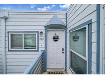 Charming condo entrance with a welcoming door, unit number, and fresh blue and white exterior at 1226 S Monaco Pkwy # 308, Denver, CO 80224