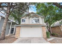 Charming two-story home with brick-accented garage, surrounded by mature trees at 2238 S Nile Ct, Aurora, CO 80014