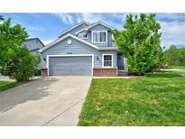 Charming two-story home featuring a well-maintained yard, gray siding, and an attached two-car garage at 2295 Sandhurst Dr, Castle Rock, CO 80104