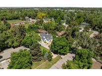 Expansive aerial view of the house surrounded by lush, mature trees in a quiet neighborhood at 1033 Estes St, Lakewood, CO 80215