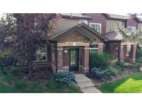 Charming townhome with brick facade and well-maintained landscaping at 6430 Silver Mesa Dr # D, Highlands Ranch, CO 80130