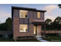 Modern two-story home featuring mixed siding, prominent windows, and a welcoming front porch at 21152 E 63Rd Dr, Aurora, CO 80019