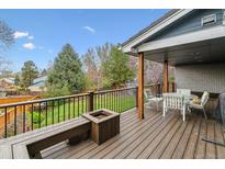 Large deck with outdoor seating, a fire pit, and a view to the backyard at 6062 S Emporia Cir, Englewood, CO 80111