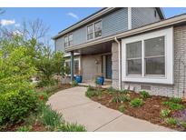 Inviting walkway leading to the front door of this charming home with beautiful landscaping at 6062 S Emporia Cir, Englewood, CO 80111