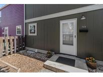 Inviting front door and walkway featuring well-kept landscaping, fresh exterior paint, and a charming entrance at 709 Arrow Ct, Lafayette, CO 80026