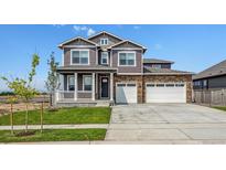 Charming two-story home with a well-manicured lawn and a three car garage at 1876 Chaffee Crest Dr, Berthoud, CO 80513