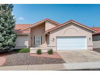 Charming home featuring a terracotta roof, manicured landscaping, and an attached two-car garage at 160 Las Lunas St, Castle Rock, CO 80104