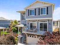 Charming two-story home with a private balcony above the garage and beautiful blue horizontal siding at 239 S Old Hammer St, Aurora, CO 80018