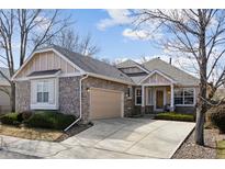 Charming stone and siding home with an attached two-car garage and well-maintained front yard at 7134 W Belmont Dr, Littleton, CO 80123