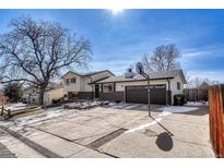 Charming two-story home with a driveway featuring a basketball hoop and a well-maintained landscaped yard at 280 Jupiter Dr, Lone Tree, CO 80124