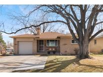 Charming brick ranch-style home with a well-maintained front yard and mature trees at 1506 S Jersey St, Denver, CO 80224