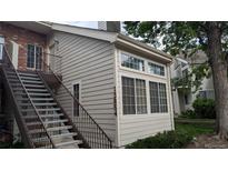 Exterior view of condo showing staircase, large windows, and neutral siding at 13854 E Lehigh Ave # D, Aurora, CO 80014