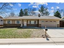 Charming ranch style home featuring a well-maintained lawn and a classic brick facade at 6966 W Fremont Pl, Littleton, CO 80128