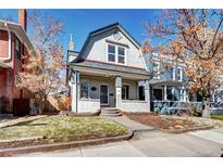 Charming two-story home with a quaint front porch and well-maintained lawn at 43 S Logan St, Denver, CO 80209