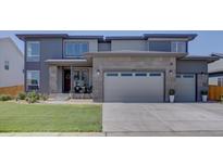 Two-story home with a well-manicured lawn and a large two-car garage at 14445 Hop Clover Trl, Parker, CO 80134