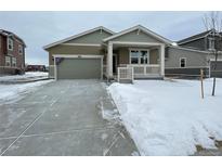 New construction home with attached garage and front porch at 16602 E 109Th Ave, Commerce City, CO 80022