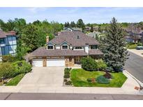 Charming two-story home featuring a three-car garage and beautifully landscaped front yard at 5694 S Pagosa Ct, Centennial, CO 80015