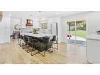 Bright kitchen with white cabinets, an island with seating, and stainless steel appliances at 9810 Venneford Ranch Rd, Highlands Ranch, CO 80126