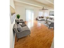 Bright living room with hardwood floors, and large windows providing ample natural light at 9995 E Harvard Ave # 177, Denver, CO 80231