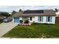 Charming single-Gathering home boasting a well-manicured lawn, solar panels, and a freshly painted garage at 19258 E Kansas Dr, Aurora, CO 80017