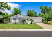 Charming single-story home with a well-maintained lawn, mature trees, and a two-car garage at 3695 W Monmouth Ave, Littleton, CO 80123