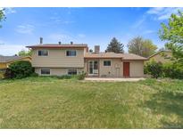 Expansive backyard with well-maintained lawn and back patio area for entertaining and outdoor enjoyment at 2453 S Memphis Way, Aurora, CO 80013