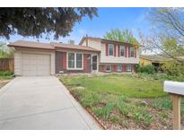 Charming two-story home with a well-kept lawn, brick accents, and an attached garage at 2453 S Memphis Way, Aurora, CO 80013