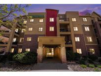 Three-story condo building with brick accents and an inviting entrance at 1144 Rockhurst Dr # 105, Highlands Ranch, CO 80129