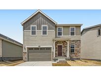 Charming two-story home featuring a stone-accented entry, attached garage, and neutral siding in a well-maintained neighborhood at 15285 Milwaukee St, Thornton, CO 80602