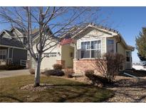 Charming single-Gathering home featuring a brick facade and well-maintained front yard at 1128 S Duquesne Cir, Aurora, CO 80018