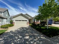 Charming single-story home featuring a well-maintained lawn and attached two-car garage at 1128 S Duquesne Cir, Aurora, CO 80018