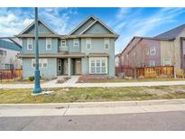 Charming two-story home featuring a well-maintained lawn and inviting entrance at 5193 N Clinton St, Denver, CO 80238