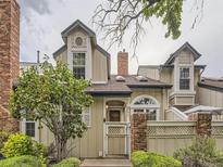 Tan two-story townhome with a charming front entrance and landscaping at 993 S Evanston Cir, Aurora, CO 80012