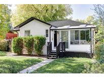 Charming updated bungalow with a sunroom and well-manicured lawn at 1315 Holly St, Denver, CO 80220