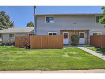 Charming home with a well-manicured lawn and inviting front entrance, featuring stone accents at 1211 W 112Th Ave # B, Denver, CO 80234