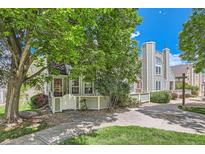 Charming home featuring mature trees, a walkway, and a well-maintained front yard at 5750 W Atlantic Pl, Lakewood, CO 80227