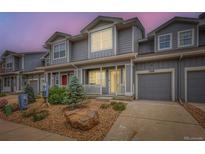 Charming townhome featuring a gray exterior, landscaped front yard, and attached one-car garage at 226 Ash St, Bennett, CO 80102