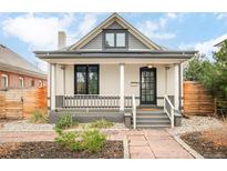 Charming home exterior featuring a covered porch, gray accents, and landscaped front yard at 2939 Osceola St, Denver, CO 80212