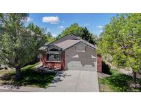 Charming single-Gathering home featuring a brick facade, well-maintained lawn, and an attached two-car garage at 2225 S Lima Ct, Aurora, CO 80014