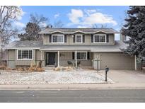 Charming two-story home featuring a covered front porch and an attached two-car garage at 5708 S Galena St, Greenwood Village, CO 80111