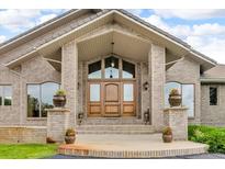 Stunning exterior entrance featuring a double door and large windows providing lots of natural light at 5881 Deer Meadow Trl, Golden, CO 80403