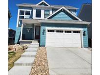 Charming blue two-story home with a spacious two-car garage and a well-manicured lawn at 8981 Bellsong Circle Cir, Littleton, CO 80125