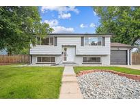 Charming two-story home with a well-maintained front yard and an inviting entrance at 2843 S Otis St, Denver, CO 80227