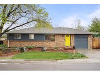 Charming brick home with a well-manicured lawn and a bright yellow front door, offering great curb appeal at 6742 Marshall St, Arvada, CO 80003
