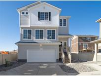 Charming two-story home with a two-car garage, white siding, and a welcoming front porch at 22083 E 38Th Pl, Aurora, CO 80019
