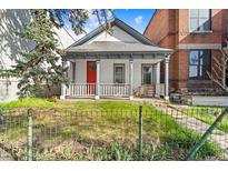 Charming home with a bright red door, quaint porch, and a well-maintained front yard at 2322 Arapahoe St, Denver, CO 80205