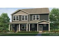 Charming gray two-story home with well-maintained lawn and inviting front porch at 1380 S Boston Ct # B, Denver, CO 80247