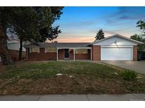 Charming brick home with a covered front porch and attached two-car garage at 396 S Troy St, Aurora, CO 80012